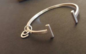 'E' charm and bangle