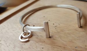 'E' charm and bangle