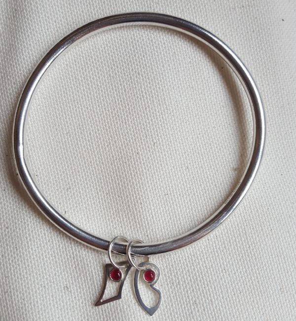 Silver bangle with rubies set letters