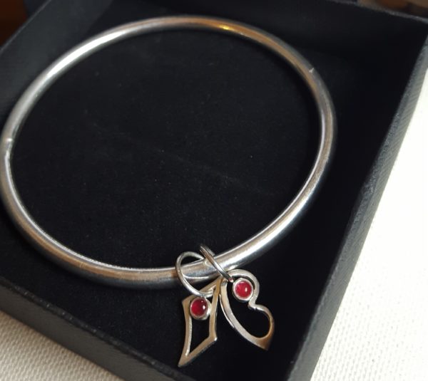 Silver bangle with rubies