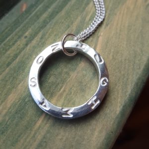 Silver circular pendant with name