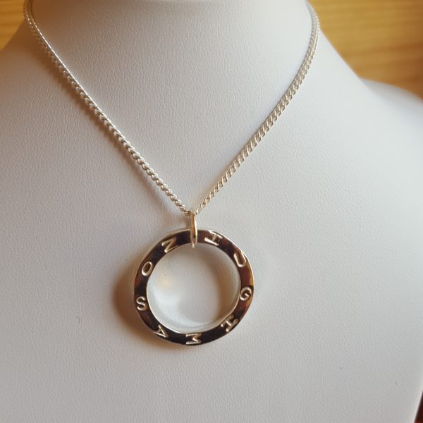 Silver circular pendant with name with curb chain