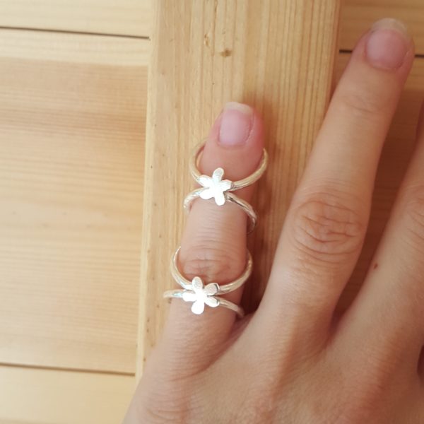 Bespoke handmade silver splint ring with flower design worn by designer