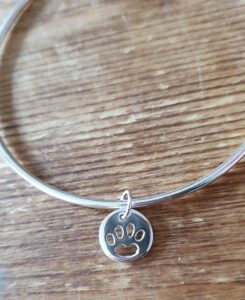 Sterling silver bangle with paw charm