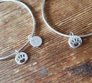 Sterling silver bangle with paw charm