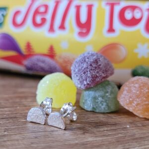 Sterling silver jelly tot earrings with a tube of jelly tots in the background