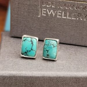 A pair of rectangular turquoise earrings set in sterling silver