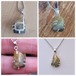 Rough sapphire in prong setting pendant.