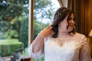 The beautiful bride on her wedding day wearing the pearl earrings.