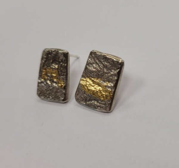 Oxidised silver pendants with a gold leaf element.
