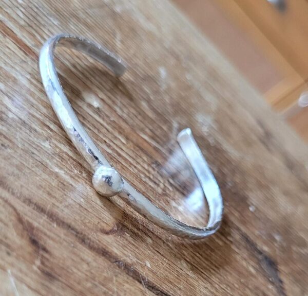 Silver cuff bangle, textured with ball detail.