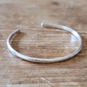 Silver cuff bangle with texture.