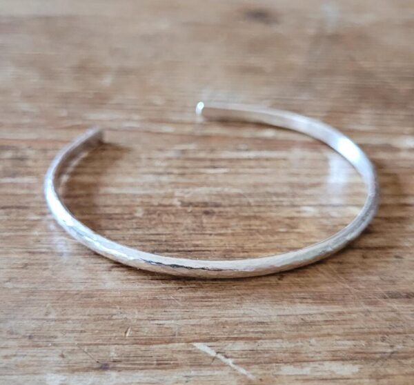 Silver cuff bangle with texture.