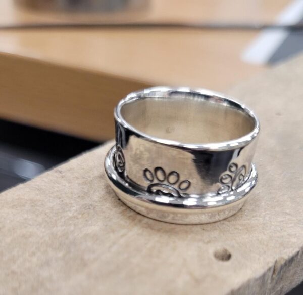 Spinner ring with a paw print design.