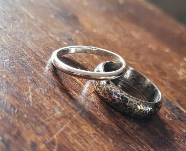 Small silver wedding ring and textured oxidised ring made in my wedding ring workshop.
