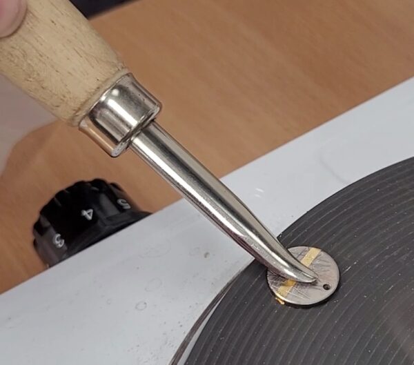 Applying gold leaf to silver as part of the technique named Keum Boo.