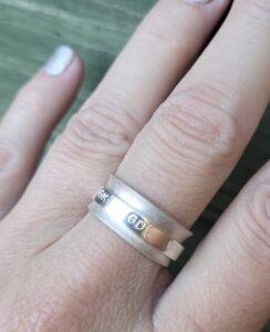 Sterling silver netball themed fidget spinner ring.