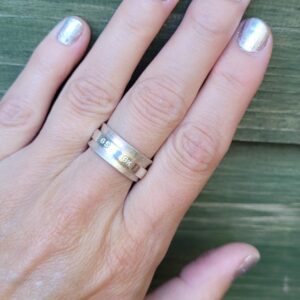 Sterling silver netball themed fidget spinner ring.