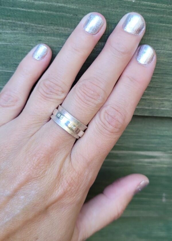 Sterling silver netball themed fidget spinner ring.